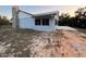 Exterior view of the home, showcasing siding, stone chimney, and side deck at 2134 R E Byrd Rd, Frostproof, FL 33843