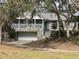 View of a charming stone house with a screened porch and built in garage at 2134 R E Byrd Rd, Frostproof, FL 33843