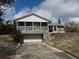 Stone-clad home featuring an attached garage and covered porch at 2134 R E Byrd Rd, Frostproof, FL 33843