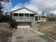 Charming home featuring stone accents, screened porch, and a convenient attached garage at 2134 R E Byrd Rd, Frostproof, FL 33843