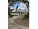 Charming home featuring stone accents, screened porch, and mature landscaping at 2134 R E Byrd Rd, Frostproof, FL 33843