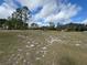 The lot offers a vast expanse of land, with a scattering of trees at 2134 R E Byrd Rd, Frostproof, FL 33843