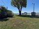 Lush backyard featuring a gazebo, utility shed, and waterfront view at 2263 Lake Reedy N Blvd, Frostproof, FL 33843