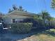 View of the carport showing mature landscaping, with a vehicle parked inside at 2263 Lake Reedy N Blvd, Frostproof, FL 33843