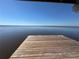 Expansive view of the calm lake from a wooden dock, perfect for relaxation and enjoying the scenery at 2263 Lake Reedy N Blvd, Frostproof, FL 33843