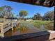 Picturesque waterfront home viewed from a gazebo on the dock with a lush lawn and tranquil lake views at 2263 Lake Reedy N Blvd, Frostproof, FL 33843