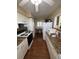 Functional kitchen with ample counter space, white cabinets, and a view into the dining area at 2263 Lake Reedy N Blvd, Frostproof, FL 33843