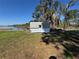 Small outbuilding sits on large open grass area close to lake at 2263 Lake Reedy N Blvd, Frostproof, FL 33843