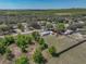 Aerial view of a house with a metal roof, a spacious backyard, and surrounded by trees at 2391 Buck Board Trl, Lake Wales, FL 33898