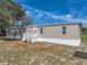 Single-story home with white trim, a metal roof, and a well-maintained yard at 2391 Buck Board Trl, Lake Wales, FL 33898