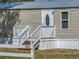 Inviting home features a decorative glass front door, complemented by a well-maintained yard and white picket fence at 2391 Buck Board Trl, Lake Wales, FL 33898