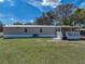 A charming home featuring a covered back porch and well-maintained lawn at 2391 Buck Board Trl, Lake Wales, FL 33898