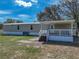 A charming home featuring a covered back porch and stairs that offer a great space for outdoor living at 2391 Buck Board Trl, Lake Wales, FL 33898