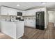 Modern kitchen featuring white cabinets, black appliances, and marble countertops at 2391 Buck Board Trl, Lake Wales, FL 33898