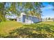 Wide view of the backyard showing the home's side and access to the garage; ample room for outdoor activities at 2616 Huntington Ct, Kissimmee, FL 34743