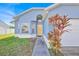 Close up exterior of a single-Gathering home featuring a well-maintained lawn and a lovely blue exterior at 2616 Huntington Ct, Kissimmee, FL 34743