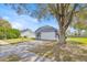 Side view of a single-Gathering home with a large front yard and an attached two-car garage with driveway at 2616 Huntington Ct, Kissimmee, FL 34743