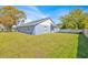 Exterior shot of the house from the backyard, showcasing the large yard and privacy fence at 2616 Huntington Ct, Kissimmee, FL 34743