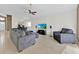 Bright living room featuring tile floors, recessed lighting, and a comfortable gray sectional at 2616 Huntington Ct, Kissimmee, FL 34743