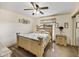 Comfortable bedroom with a ceiling fan, carpeted floors, ornate furnishings, and plenty of natural light at 2656 S Scenic Hwy, Lake Wales, FL 33898