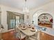 Elegant dining room with a chandelier, hardwood floors, and an arched entrance to the living room at 2656 S Scenic Hwy, Lake Wales, FL 33898