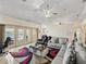 Bright living room featuring a ceiling fan, cozy sofas, and sliding glass doors to the patio and pool at 2656 S Scenic Hwy, Lake Wales, FL 33898