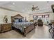 Spacious main bedroom featuring an ornate bed frame, ceiling fan, and sitting area with water view at 2656 S Scenic Hwy, Lake Wales, FL 33898