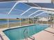 Screened-in pool with lake view and metal ladder at 2656 S Scenic Hwy, Lake Wales, FL 33898