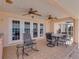 Spacious covered patio with seating and dining areas overlooking the serene pool and lake at 2656 S Scenic Hwy, Lake Wales, FL 33898