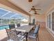 Covered patio features a dining table and outdoor seating area with a view of the pool at 2656 S Scenic Hwy, Lake Wales, FL 33898