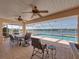 Covered patio featuring a dining area and a view of the pool and lake at 2656 S Scenic Hwy, Lake Wales, FL 33898