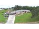 Aerial view of a well-maintained home with a lush green lawn and convenient carport at 301 S Clinch Lake Blvd, Frostproof, FL 33843