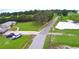Aerial view featuring a home with well-maintained landscaping, circular drive, and nearby lake at 301 S Clinch Lake Blvd, Frostproof, FL 33843