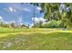 Expansive backyard showing a view of a fenced property line with mature landscaping at 301 S Clinch Lake Blvd, Frostproof, FL 33843