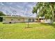 Spacious backyard with healthy green grass, mature trees, and room to roam at 301 S Clinch Lake Blvd, Frostproof, FL 33843