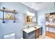 Charming bathroom with double sinks, granite countertops, and a rustic mirror frame at 301 S Clinch Lake Blvd, Frostproof, FL 33843