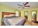 Spacious bedroom with hardwood floors, ceiling fan, and mirrored closet doors for ample storage at 301 S Clinch Lake Blvd, Frostproof, FL 33843