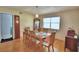 Cozy dining room boasts hardwood floors, natural light, and a table set for six at 301 S Clinch Lake Blvd, Frostproof, FL 33843