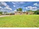Well-maintained home with a lush green lawn, circular driveway, and a carport for added convenience at 301 S Clinch Lake Blvd, Frostproof, FL 33843