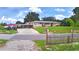 Charming single-story home featuring a carport, well-manicured lawn, and a classic picket fence at 301 S Clinch Lake Blvd, Frostproof, FL 33843
