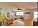Comfortable living room features hardwood floors, ceiling fans, plush seating, and bright windows at 301 S Clinch Lake Blvd, Frostproof, FL 33843