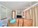 Comfortable living room with a large sofa, television, and easy access to the outside at 301 S Clinch Lake Blvd, Frostproof, FL 33843