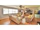 Bright living room with comfy seating, ceiling fans, hardwood floors, and a lake view window at 301 S Clinch Lake Blvd, Frostproof, FL 33843