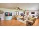 Inviting living room boasts an aquarium, hardwood floors, ceiling fans, and comfortable seating at 301 S Clinch Lake Blvd, Frostproof, FL 33843