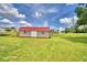 Backyard featuring a shed with a red roof with plenty of surrounding lawn at 301 S Clinch Lake Blvd, Frostproof, FL 33843