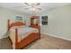 Cozy bedroom featuring a wood-framed bed, matching dresser, and natural light at 3123 Mar Lisa Cove Rd, Lake Wales, FL 33898