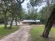Ranch-style brick house on a sprawling, tree-lined property featuring a detached garage at 3123 Mar Lisa Cove Rd, Lake Wales, FL 33898