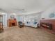 A cozy living room with hardwood floors, a brick fireplace, and comfortable seating arrangements at 3123 Mar Lisa Cove Rd, Lake Wales, FL 33898