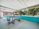 Covered patio featuring an outdoor dining set and scenic views of the backyard at 3123 Mar Lisa Cove Rd, Lake Wales, FL 33898