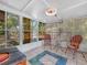 The sunroom boasts tile flooring, large windows, and a ceiling fan for a relaxing atmosphere at 3123 Mar Lisa Cove Rd, Lake Wales, FL 33898